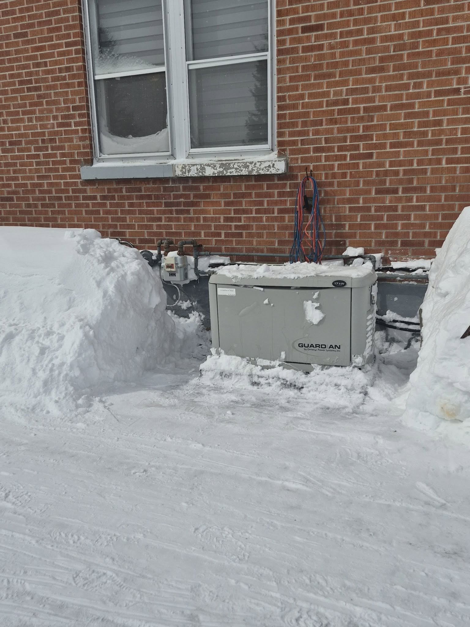 Snow removal beside a house in winter
